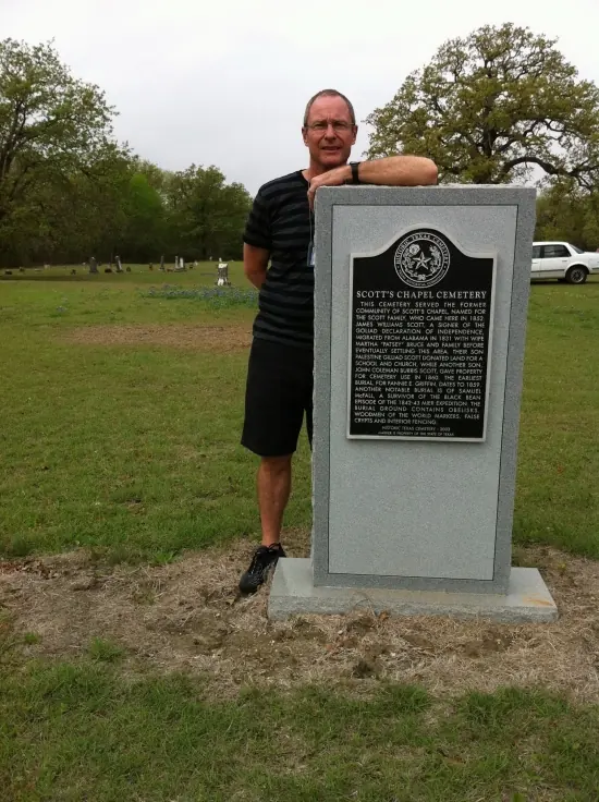 Bob Roe Scott standing aside Texas State Historical Marker of Scott's Chapel Cemetery