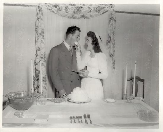 Lynn and Martha Scott wedding cake first bite, 1948